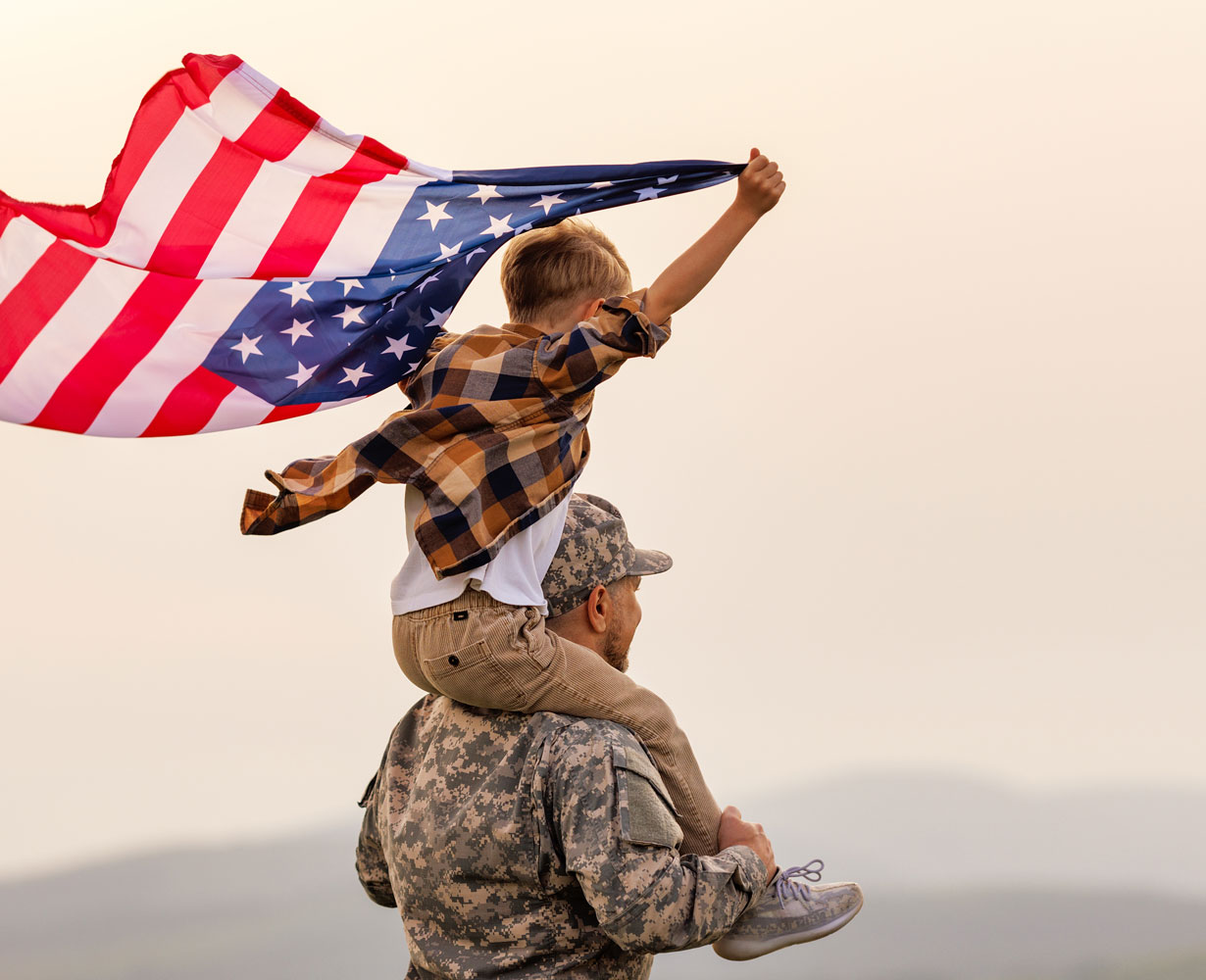 military dad with kid and flag